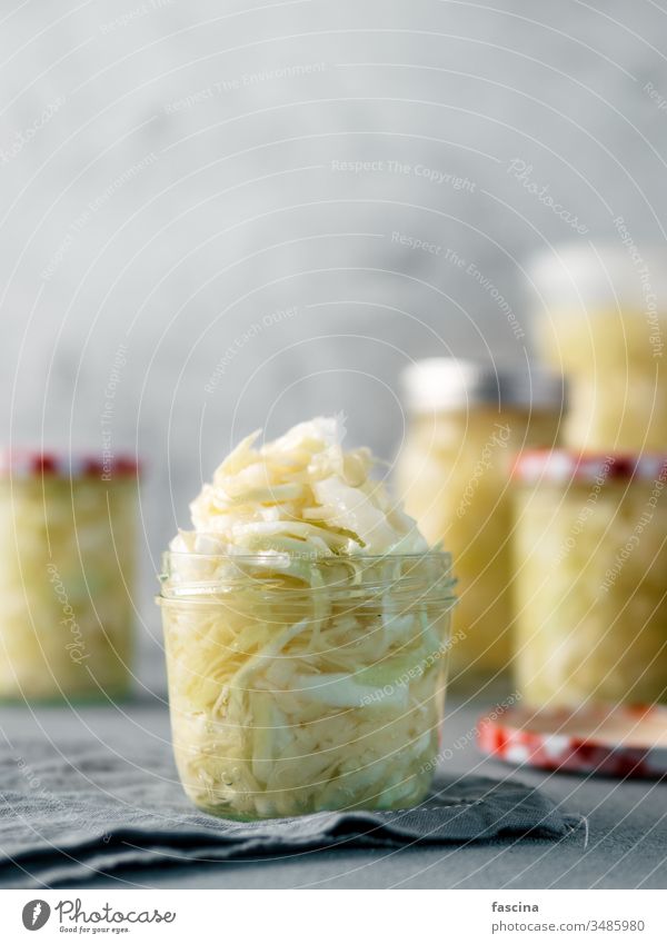 Sauerkraut in open glass jar, copy space sauerkraut cabbage fermented food dish raw barrel sour cumin salad stewed background white homemade pickled coleslaw