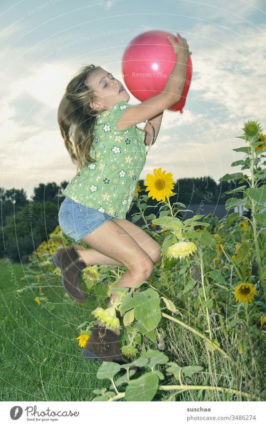 Girl catches a balloon in a jump Child Balloon Catch Playing Action Movement Flash photo flashed pose Landscape Field Nature Sunflower Summer red balloon