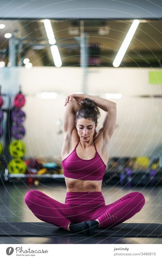Yoga exercise 'standing scale' in the fitness room, Stock Photo