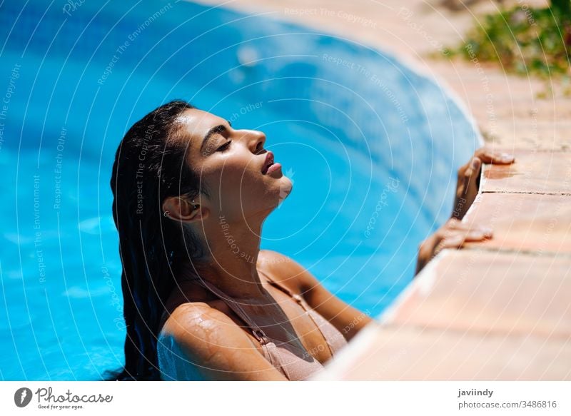 Young Arabic Woman with Beautiful Body in Swimwear Smiling on a