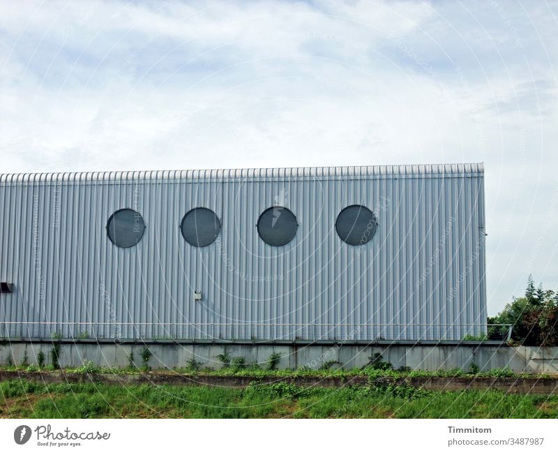 The beauty in the eye of the beholder | facade Building Architecture Commercial building Facade lines Metal Window Round Concrete Grass Sky Clouds expedient