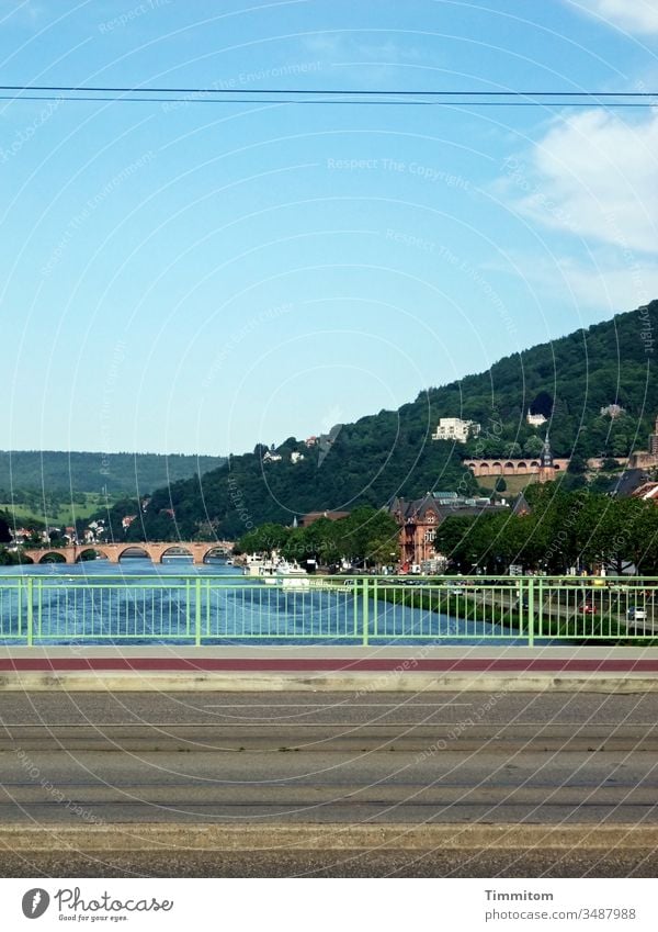 A Heidelberg street with a bit of background Street Traffic lane Asphalt trottoir Cycle path rail Neckar Bridge Hill wooded Sky Blue River