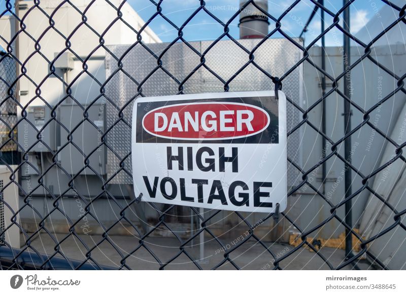 Danger high voltage sign on a fence high-voltage warning sign industrial volts pole entry blue line transformer industry supply current transmission station