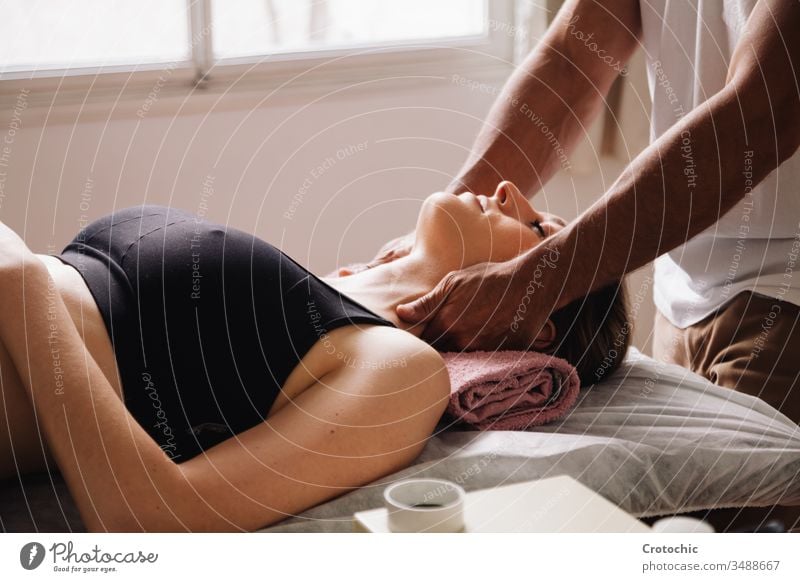 less than one masseur performing a neck massage to a beautiful woman lying down alternative aromatherapy arthritis back being bodycare bone chiropractor clinic