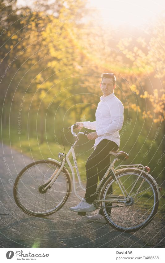 Man rides a bicycle through nature and makes a bicycle tour Cycling Bicycle Cycling tour Sunlight Beautiful weather fun Joy Nature relaxation Love of nature