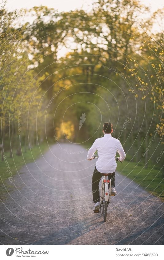 young man rides his bicycle through nature and makes a bicycle tour Cycling Bicycle Cycling tour Man Sunlight Summery Beautiful weather fun Joy Nature