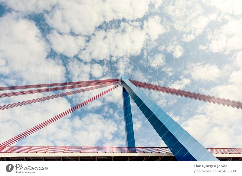 Suspension bridge over a river with blue sky and clouds Highway Bridge Brook Beach cars transfer Street River piers bank Clouds Transport Sky Manmade structures