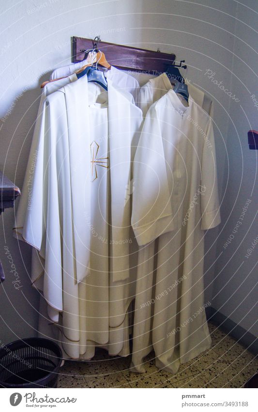 clothing and vestments of the priest for the Holy Mass friar brother priestly sacristy jesus man liturgical prayer symbolic medieval amice lab coat stole