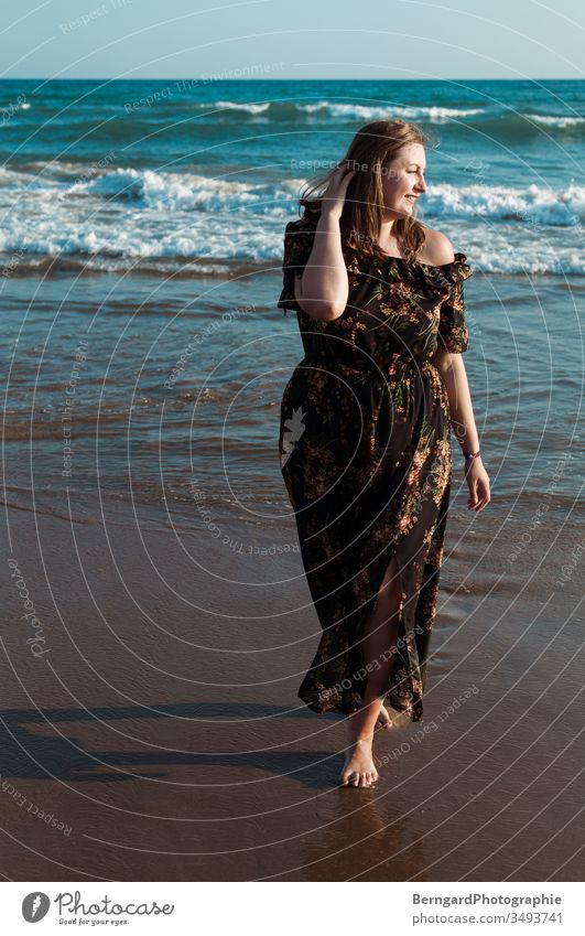 Girl at sea Ocean Water Blue Beach buzzer Sun Woman happy Warm colour smile