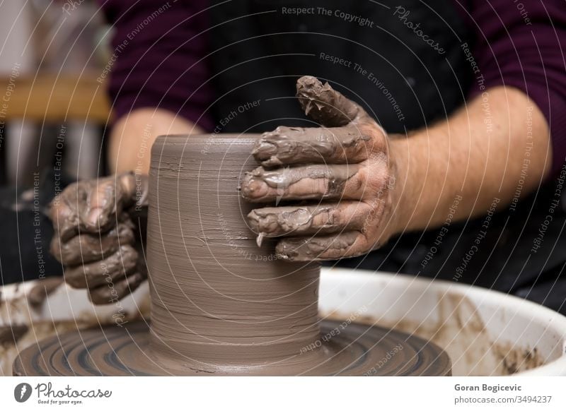 Artist makes clay pottery on a spin wheel art artist bowl ceramic craft creating creation creative creativity dirty finger form hand handmade making