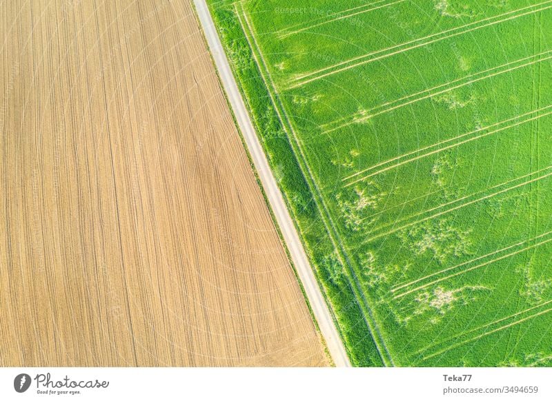an agricultural landscape from above agricultural way tractor tractor path field background meadow background air aerial view aerial photo texture grass farm