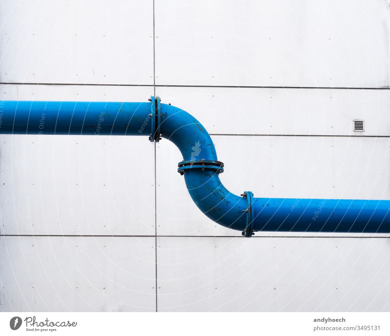 A water pipeline across the city in front of a plain facade architecture Background blue building building exterior built structure connected connecting