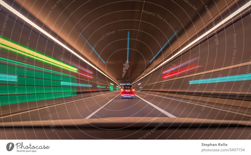 Fast driving car through a tunnel with blurry light effects, a urban race scene with leading lines and symmetry structure. speed fast background pattern