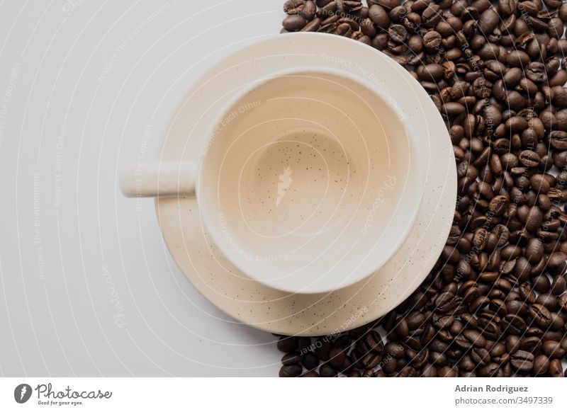 Emty white coffee cup with coffee beans and a white background dark food seed brown caffeine drink roasted beverage espresso ingredient black cafe natural