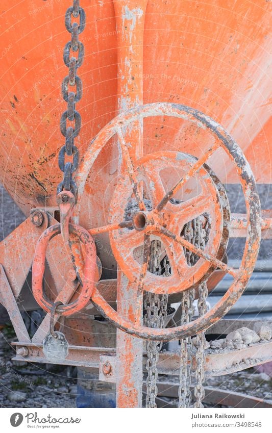 Concrete mixer on a construction site Chain link Rust Metal Colour photo Exterior shot Deserted Old Steel Safety Shallow depth of field Strong Attachment Detail
