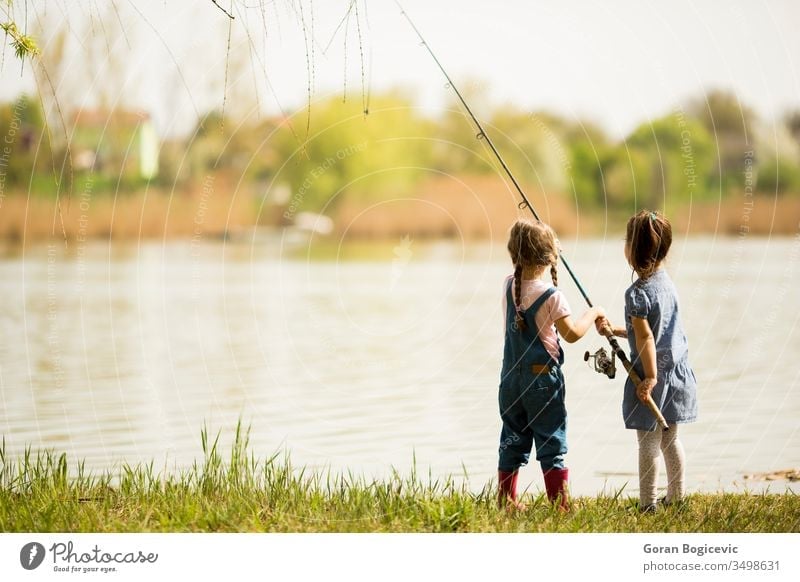 Two little girls fishing - a Royalty Free Stock Photo from Photocase