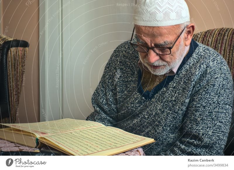 Ankara/Turkey - 24.04.2020: Very old Turkish muslim man reciting Qur'an in Ramadan elderly very old 80s male person bearded islam moslem reading recitation