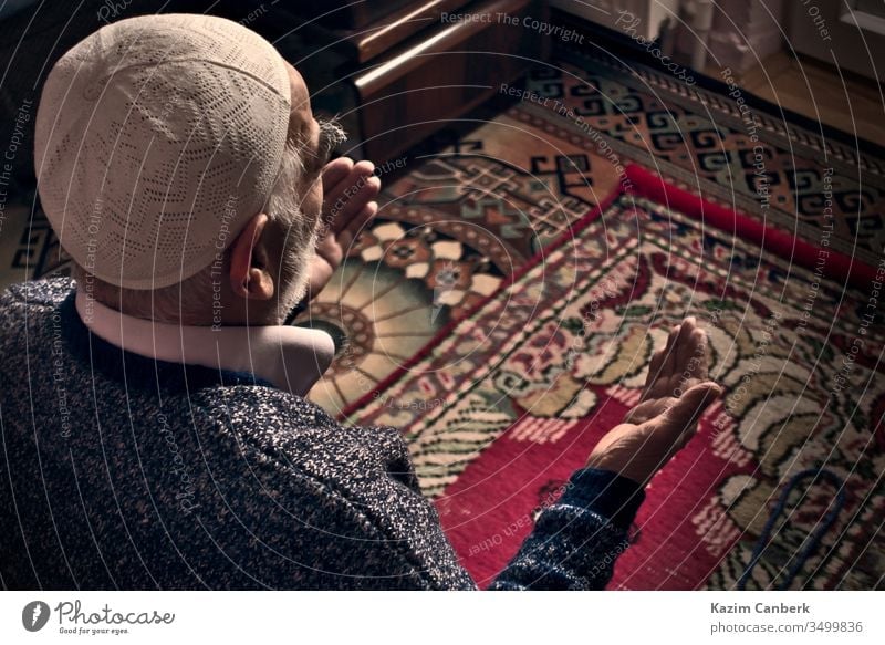 Very old Turkish Muslim man at his 80's praying to Allah at home on his rug elderly male person prayer prayer cap islam muslim moslem bearded carpet turkey