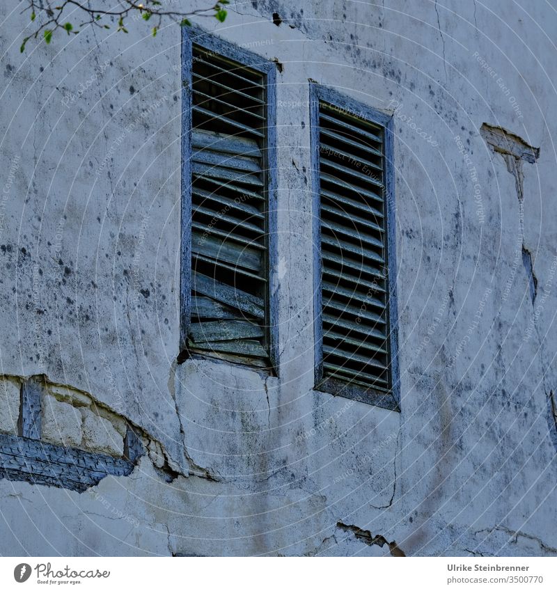 Dark old building facade with shutters made of wooden lamellas slats wood lamellas House (Residential Structure) built Facade Old building forsake sb./sth.