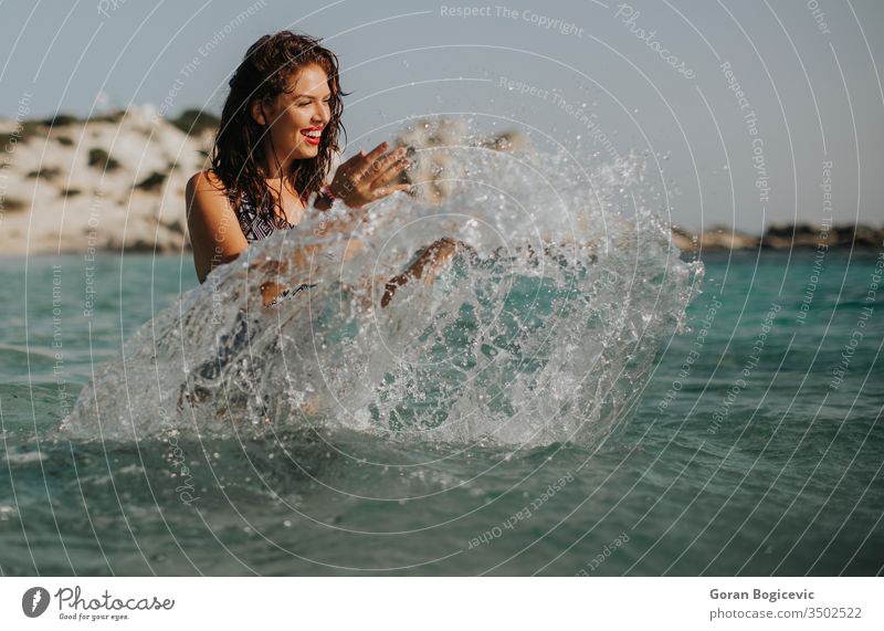 Young woman walking in the warm sea water at summer beautiful beach beauty holiday vacation travel young tourism nature relax female coast horizon blue enjoy