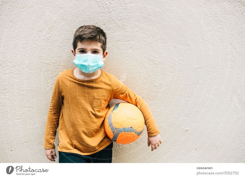 Little boy with a ball and protective mask. 2019-ncov allergy alone child childhood corona corona virus coronavirus covid-19 covid19 cute epidemic face