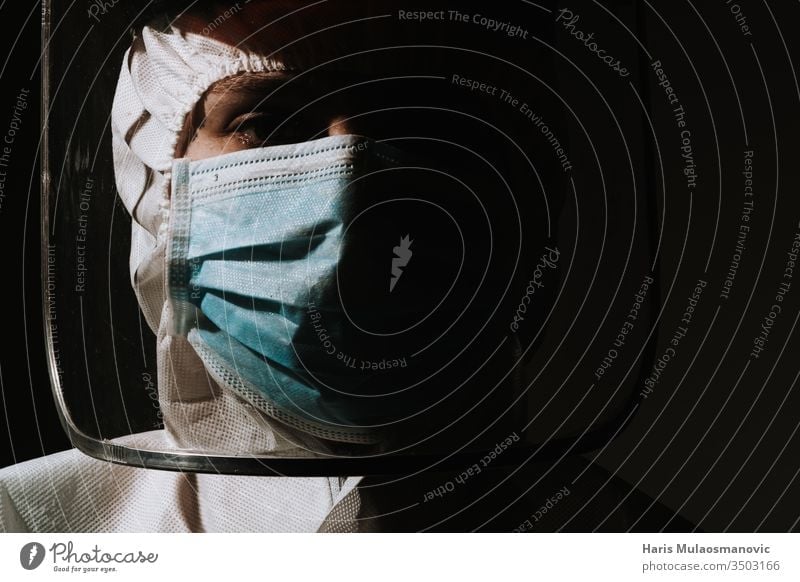 Female hero doctor with mask and face shield crying tear due to coronavirus covid-19 situation air mask black background blood brazil clinic corona epidemic