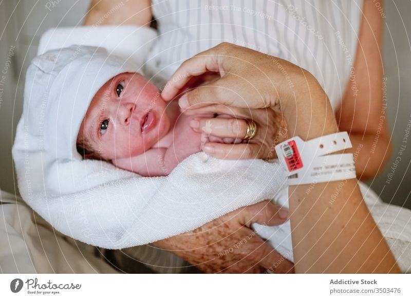 Woman visiting daughter with newborn baby in hospital mother grandmother women care bed greeting clinic happy neonatal kid medicine parent multi generational