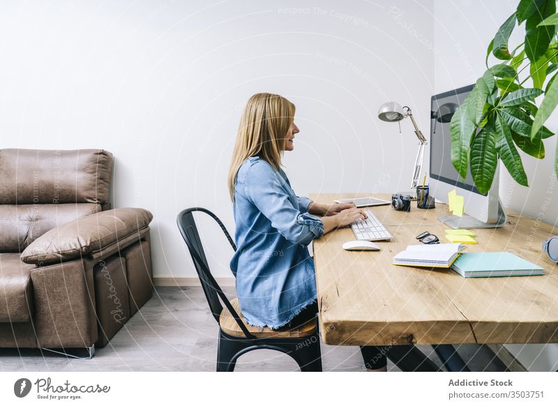 Blonde woman working at home desk young computer communication businesswoman indoor smart table female laptop desktop design lifestyle office freelance