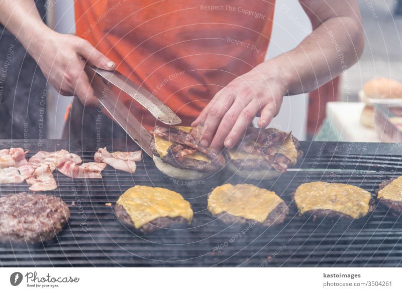 Beef burgers ready to serve on food stall. hamburger street street food beef bun fast meat snack outdoors cuisine seller vendor catering lunch meal delicious