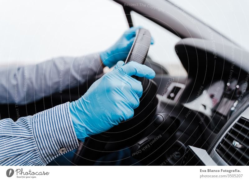 unrecognizable man driving a car wearing protective mask and gloves during pandemic coronacirus covid-19 coronavirus protective gloves infect automobile health
