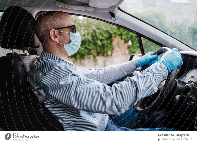 man driving a car wearing protective mask and gloves during pandemic coronacirus covid-19 coronavirus protective gloves infect automobile health transport air