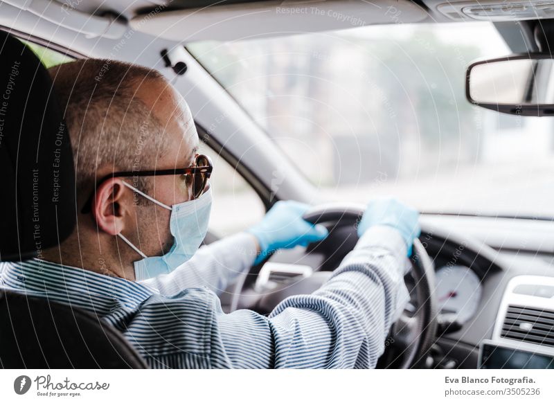 man driving a car wearing protective mask and gloves during pandemic coronacirus covid-19 coronavirus protective gloves infect automobile health transport air