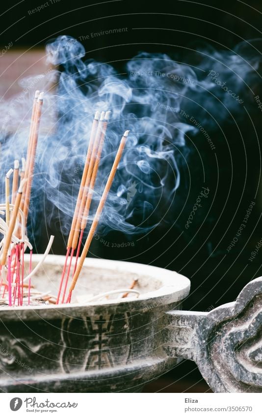 Smoking burning incense sticks in a bowl in front of a temple Joss sticks Smoke smoke Burn smoking smoke out Buddhism Hinduism Holy Asia Religion and faith