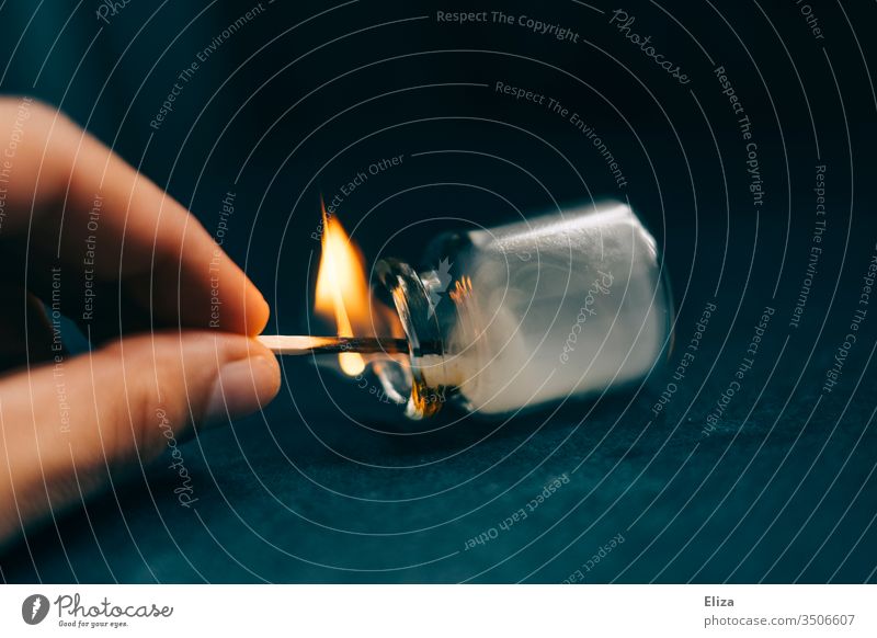 A hand experimenting with a burning match and holding it in an apothecary's flask, in which smoke then forms Match Flame Phial Hand stop Burn Fire Experimental