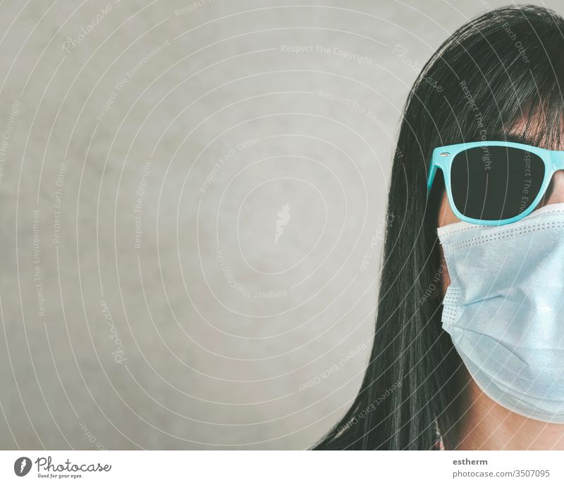 woman wearing medical mask for coronavirus with sunglasses young woman covid-19 virus epidemic pandemic quarantine cool summer lifestyle sign sad sadness