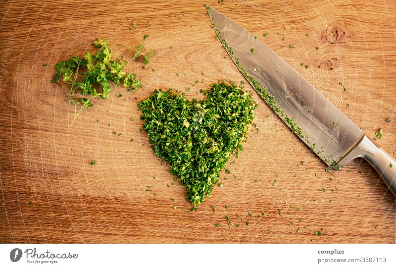 Herbs love | cut parsley in heart shape Parsley heart-shaped Heart Love vegan Vegan diet Herbs and spices Knives Chopping board cutting knife Wooden table