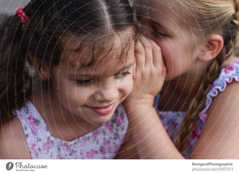 Two sisters play games - a Royalty Free Stock Photo from Photocase