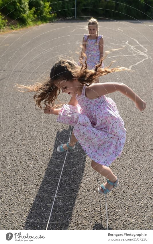 Two sisters play games Playing playtime girls children jumpin Dress Summer Sun