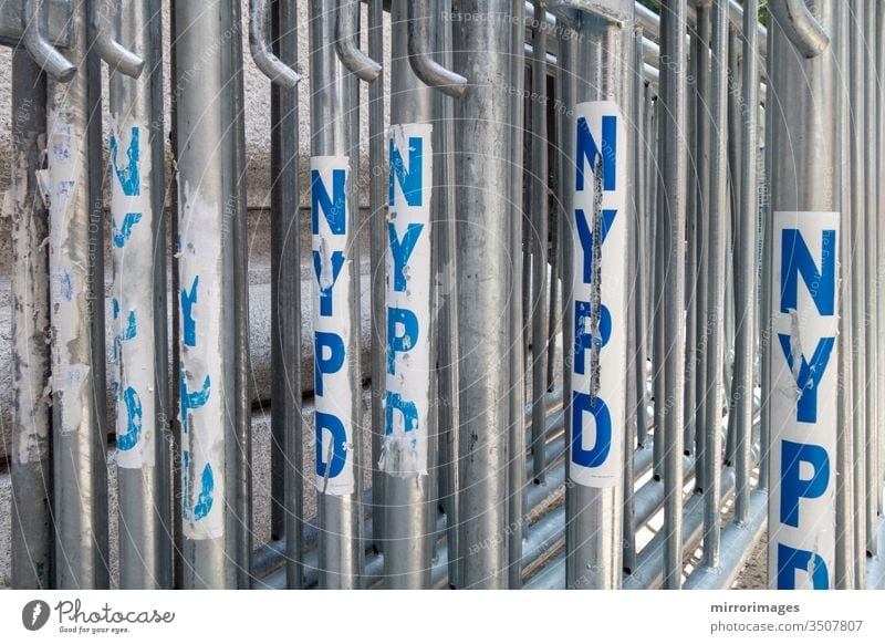 NYPD police metal blocking gates in a line ready to be assembled crowd parade construction barrier safety boundary forbidden urban transportation do not cross