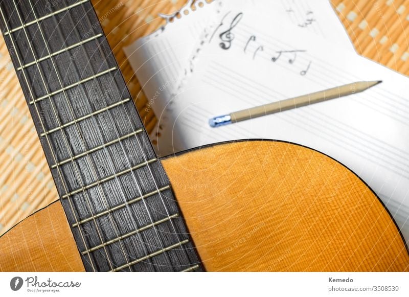 Top view of a classical guitar, music notebook with stave and pencil. Concept of composing or studying music. compose musical staff guitarist musician