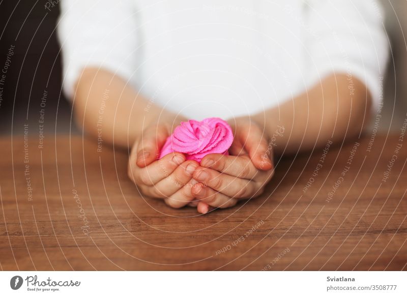 The child is holding a toy called mucus, the child is having fun and experimenting. slime game background hand white novelty entertainment isolated abstract