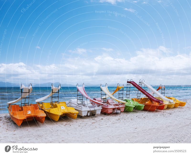 colourful pedal boats lying on the beach of Mallorca variegated Colour photo Exterior shot Multicoloured Red Day Orange green Yellow Deserted Blue Pedalo motley