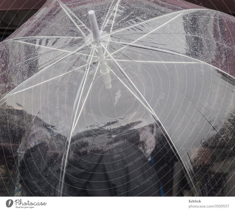 Transparent umbrella with raindrops photographed from above Umbrella transparent Drops of water Human being person Polyurethane Plastic Packing film