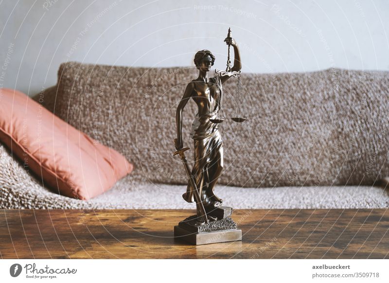 lady justice or justitia statue on table - landlord and tenant law tenancy right residence abode legislation domestic room home jurisprudence symbol concept