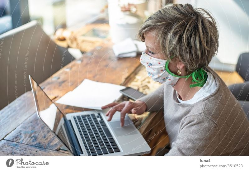 Woman with mouth guard working on laptop Mask Home Office labour at home room House (Residential Structure) Blonde Calculator Computer Quarantine technology