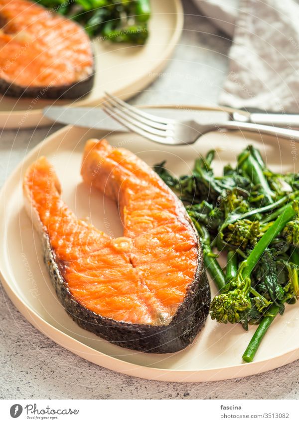 Ready-to-eat grilled salmon steak and greens baby broccoli broccolini spinach plate keto diet healthy food brain throught fish omega3 omega6 fat fatty good