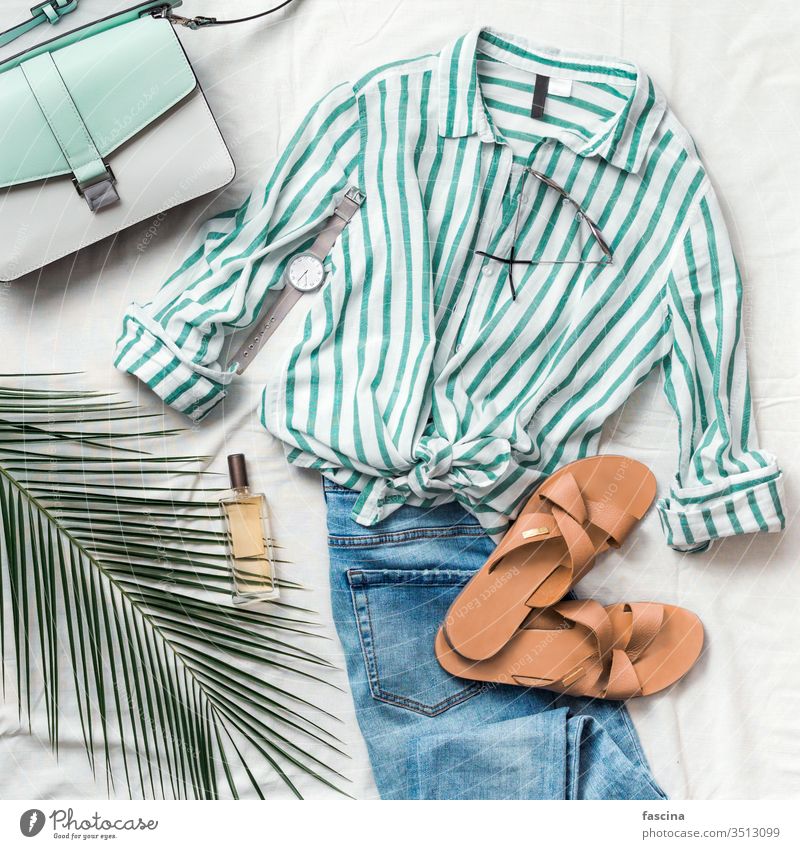 Female fashion clothes flat lay, square flatlay slippers feminine summer composition striped blouse bag sunglasses watch perfume jeans palm leaf white