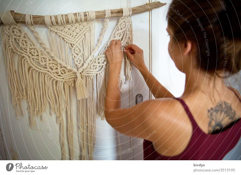 Young woman creatively engaged in macramé work at home stay home Macramé Creativity Handcrafts active stay at home Employment ideas Productive Knot knot