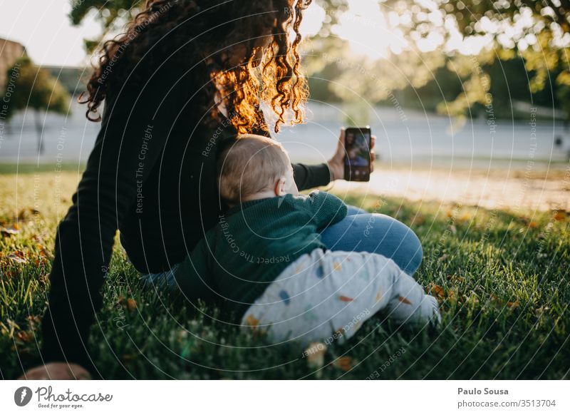 Mother and baby taking selfie photo Technology smartphone Selfie taking photo Together Lifestyle Joy Smiling Exterior shot Telephone Woman Happy Summer