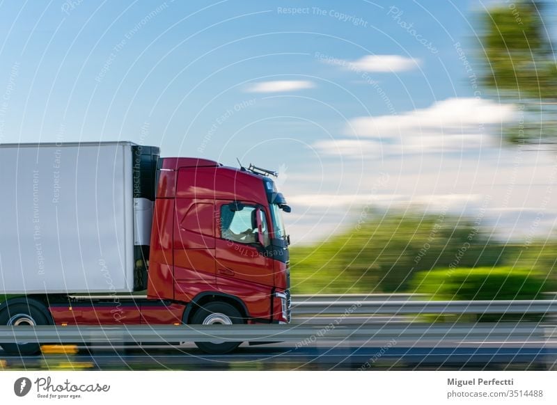 Truck with refrigerated semi-trailer driving on the highway with a blue sky with some clouds truck controlled temperature cargo moving perishable shipping road